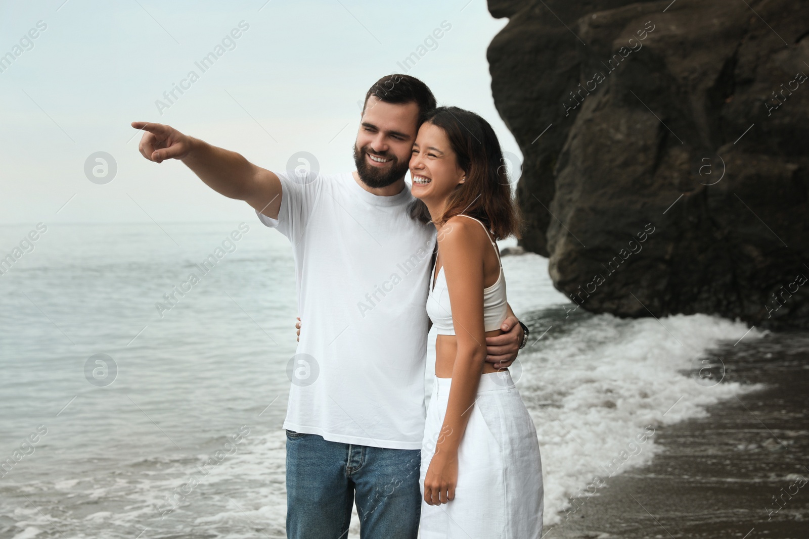 Photo of Happy young couple on beach near sea