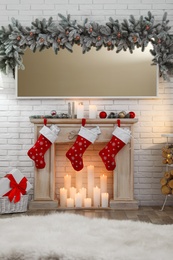 Photo of Decorative fireplace in stylish room interior. Christmas celebration