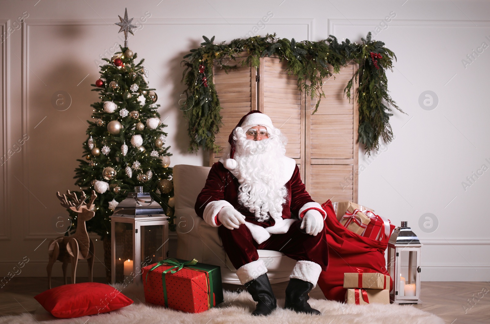 Photo of Santa Claus in photo zone decorated for Christmas