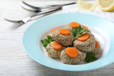 Photo of Plate of traditional Passover (Pesach) gefilte fish on wooden background, closeup
