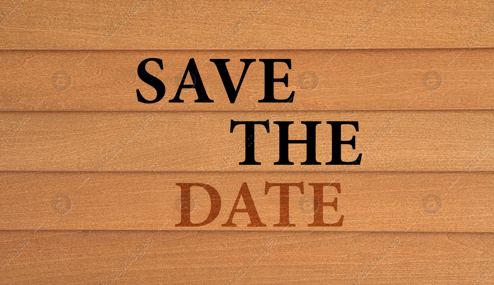 Image of Phrase SAVE THE DATE on wooden wall