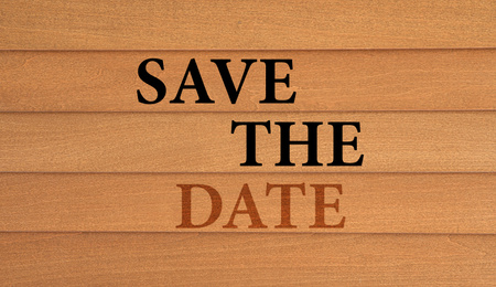 Phrase SAVE THE DATE on wooden wall