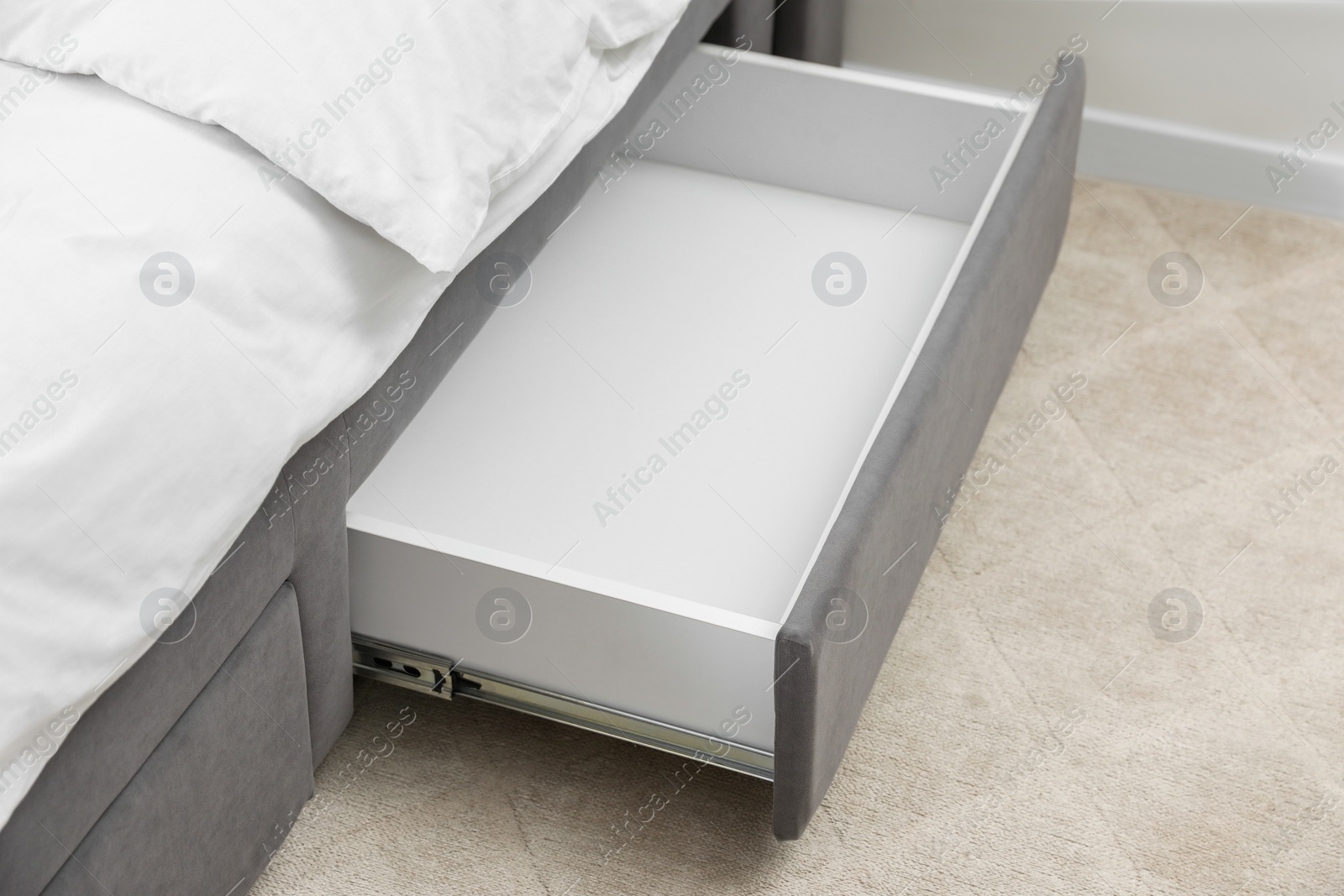 Photo of Storage drawer for bedding under modern bed in room
