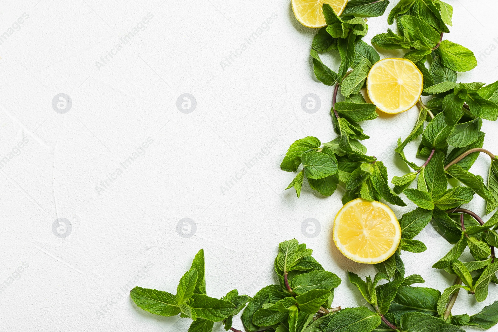 Photo of Flat lay composition with mint and citrus fruit on light background