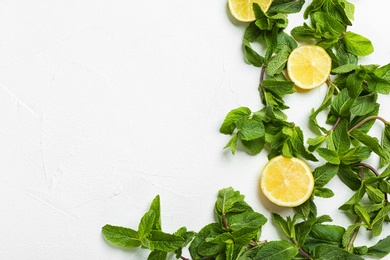 Flat lay composition with mint and citrus fruit on light background