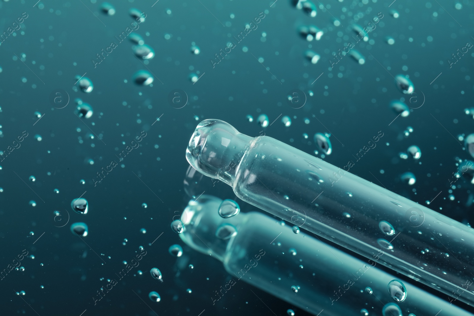 Photo of Pipette and serum drops on mirror, closeup with space for text. Color tone effect