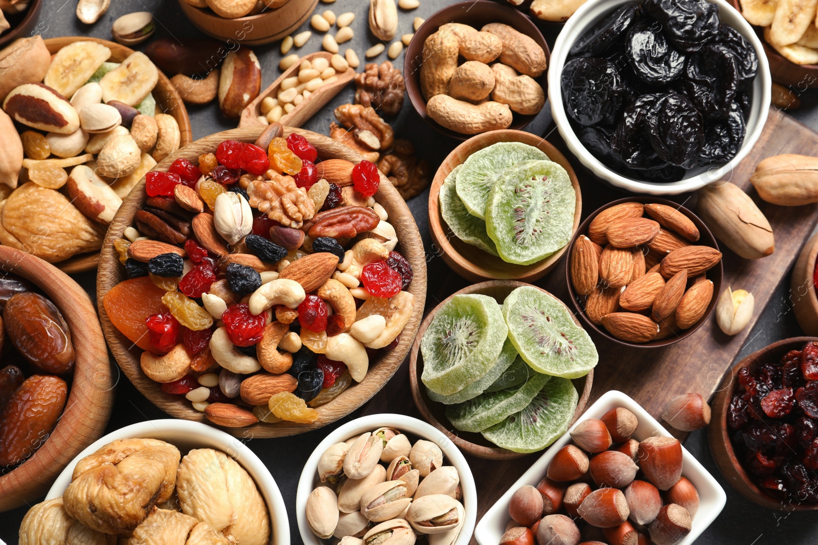 Photo of Flat lay composition of different dried fruits and nuts on table