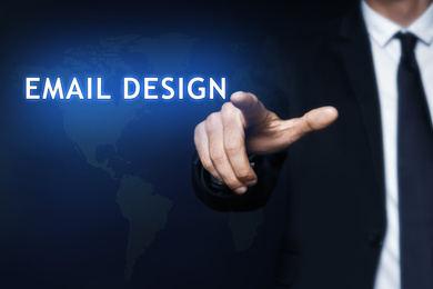 Businessman pointing at phrase EMAIL DESIGN on virtual screen, closeup