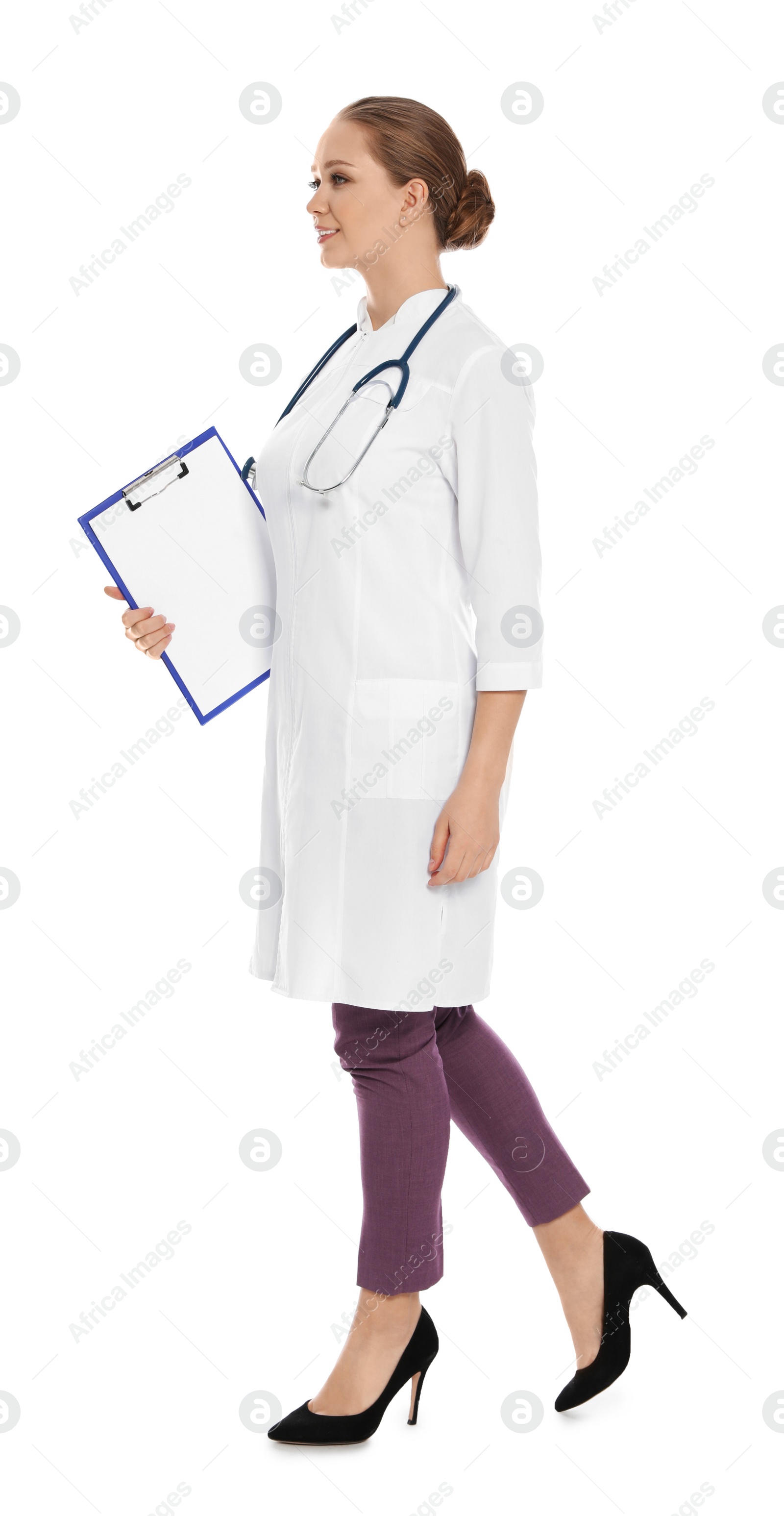 Photo of Full length portrait of medical doctor with clipboard and stethoscope isolated on white