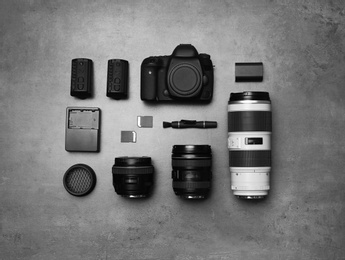 Flat lay composition with professional photographer equipment on gray background