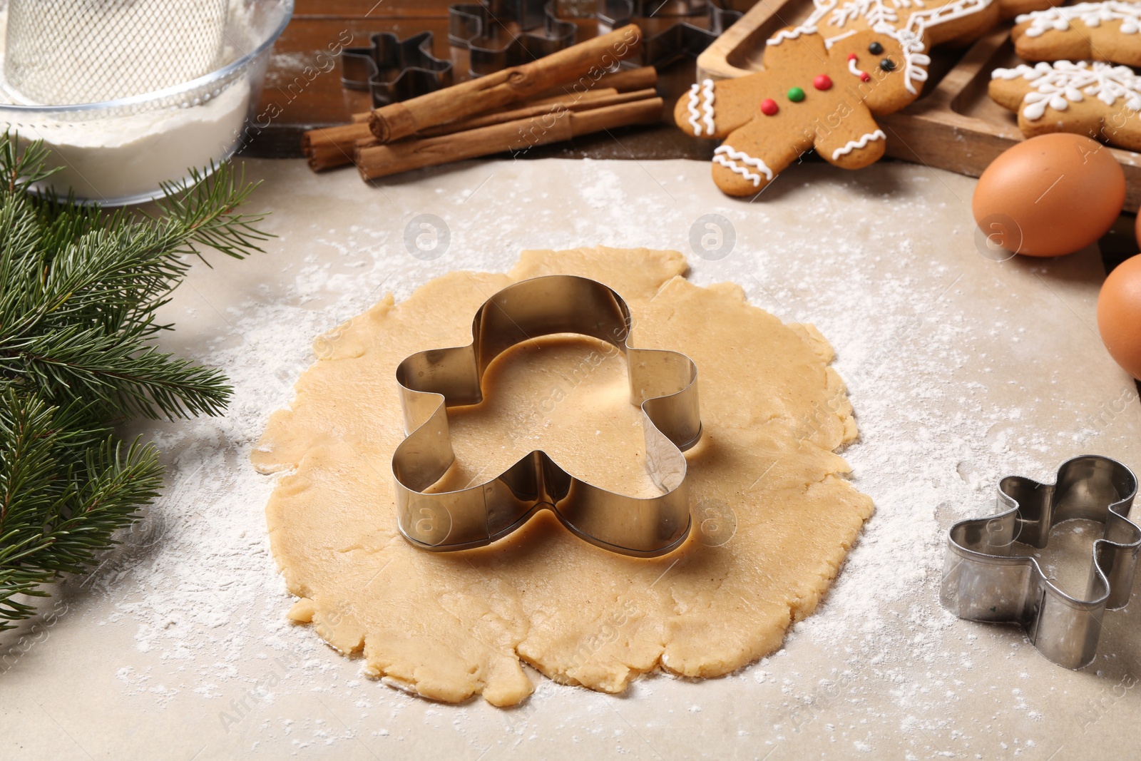 Photo of Making Christmas cookies. Raw dough and metal cutters on table