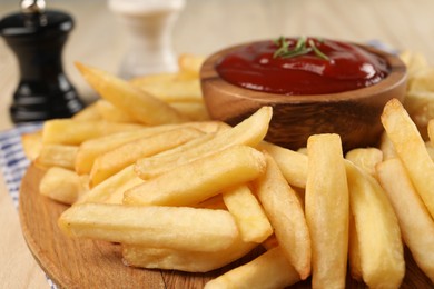 Delicious french fries with ketchup on table, closeup