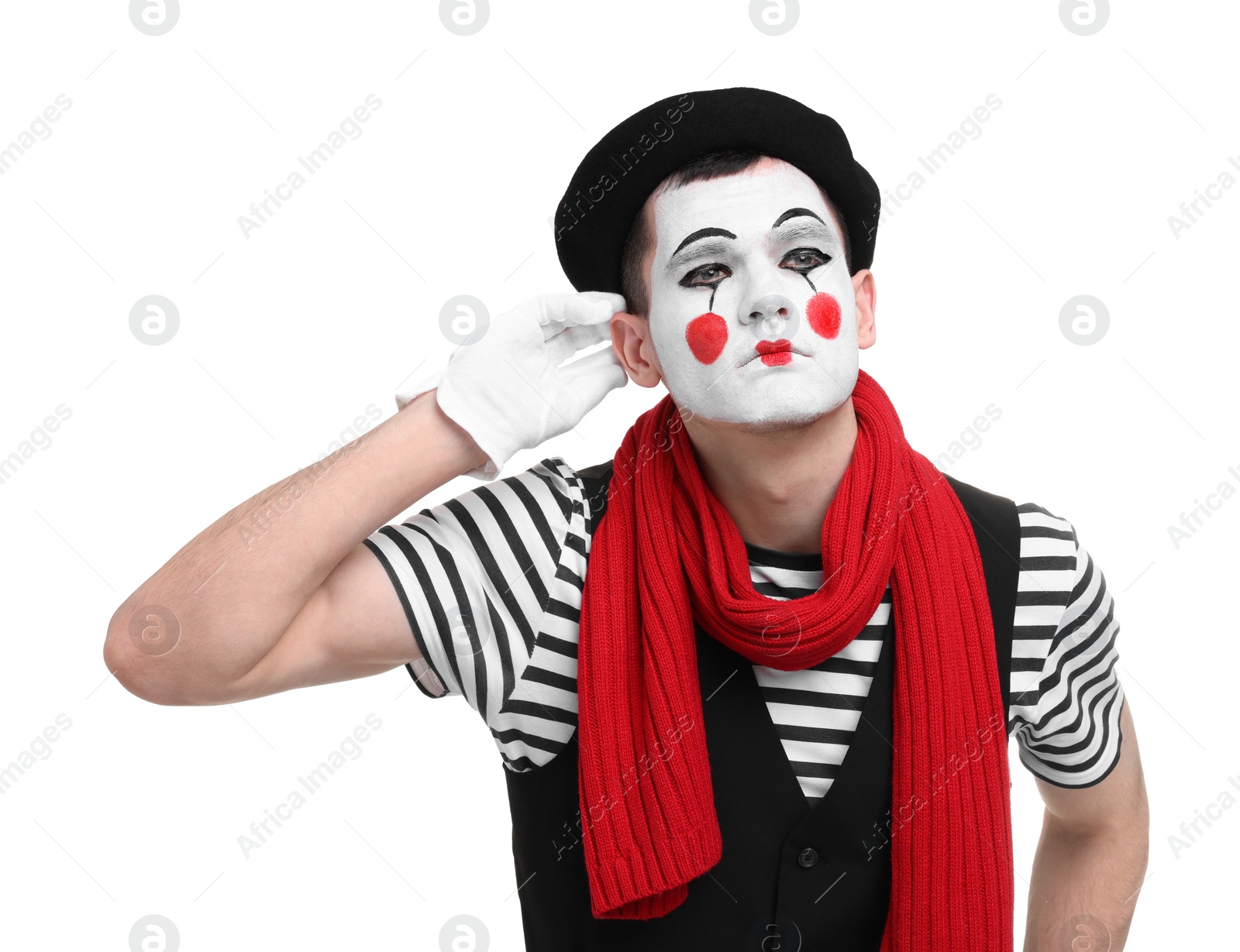 Photo of Mime artist showing hand to ear gesture on white background