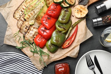 Delicious grilled vegetables served on dark grey table, flat lay