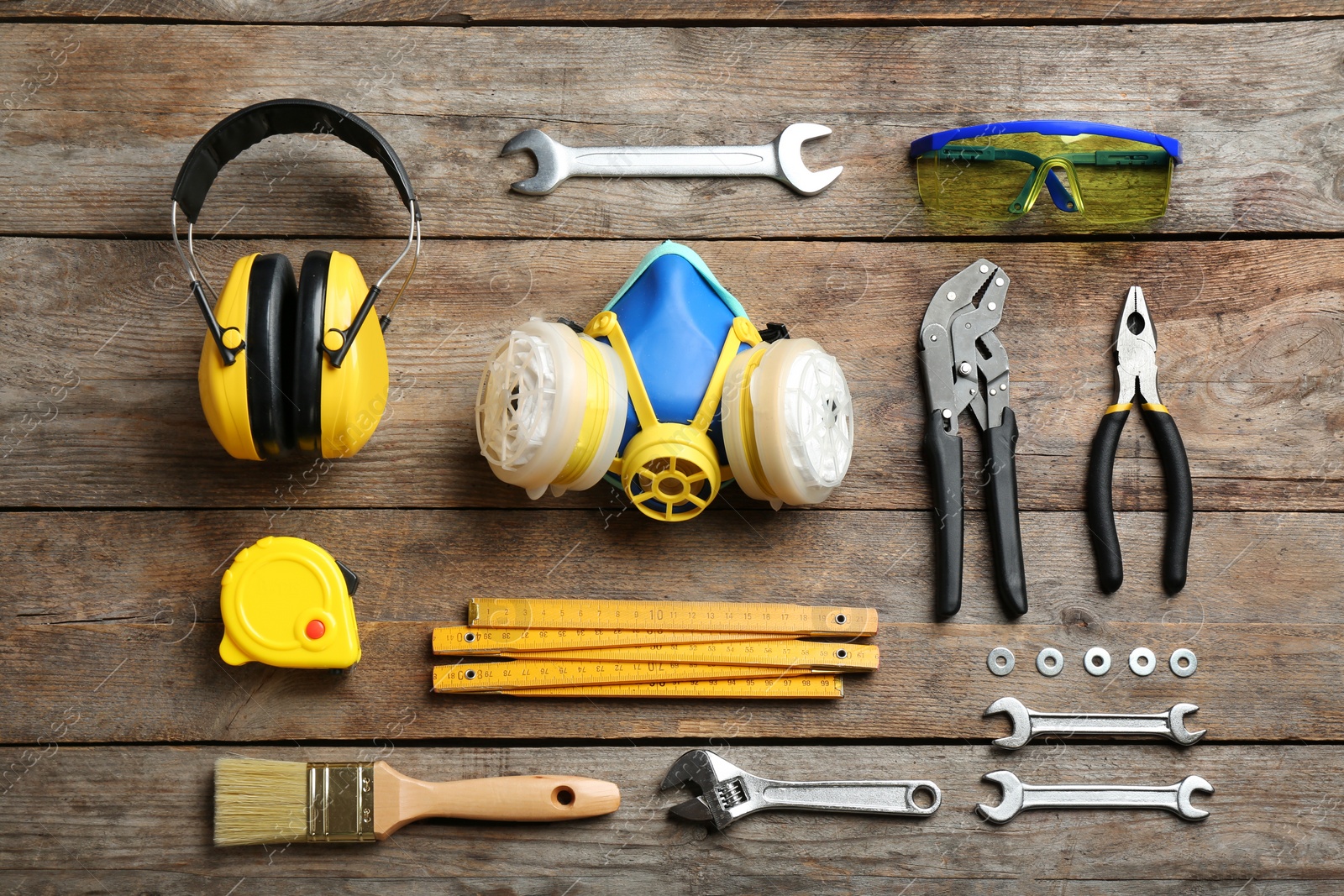 Photo of Flat lay composition with construction tools on wooden background