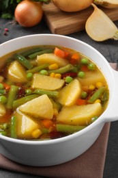 Bowl of delicious turnip soup on grey table, closeup