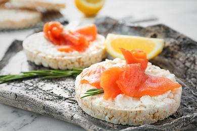 Photo of Crispbreads with fresh sliced salmon fillet on plate