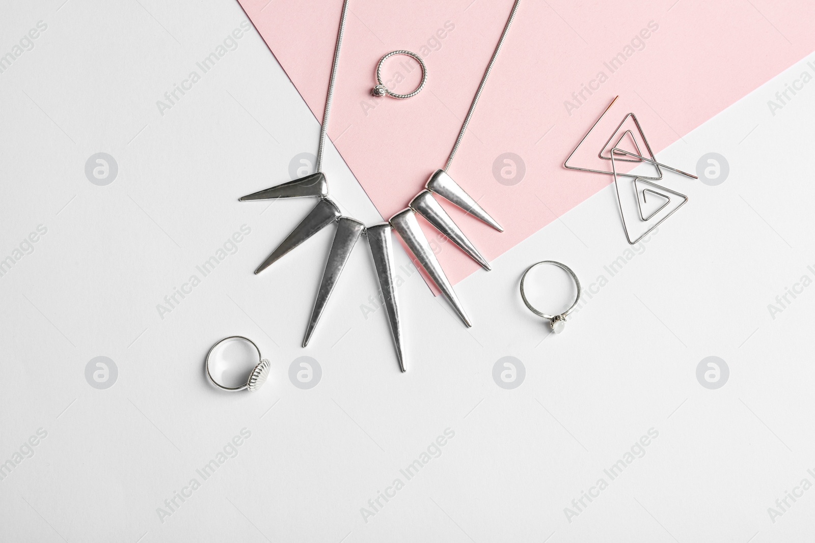 Photo of Set of elegant jewelry on color background, top view