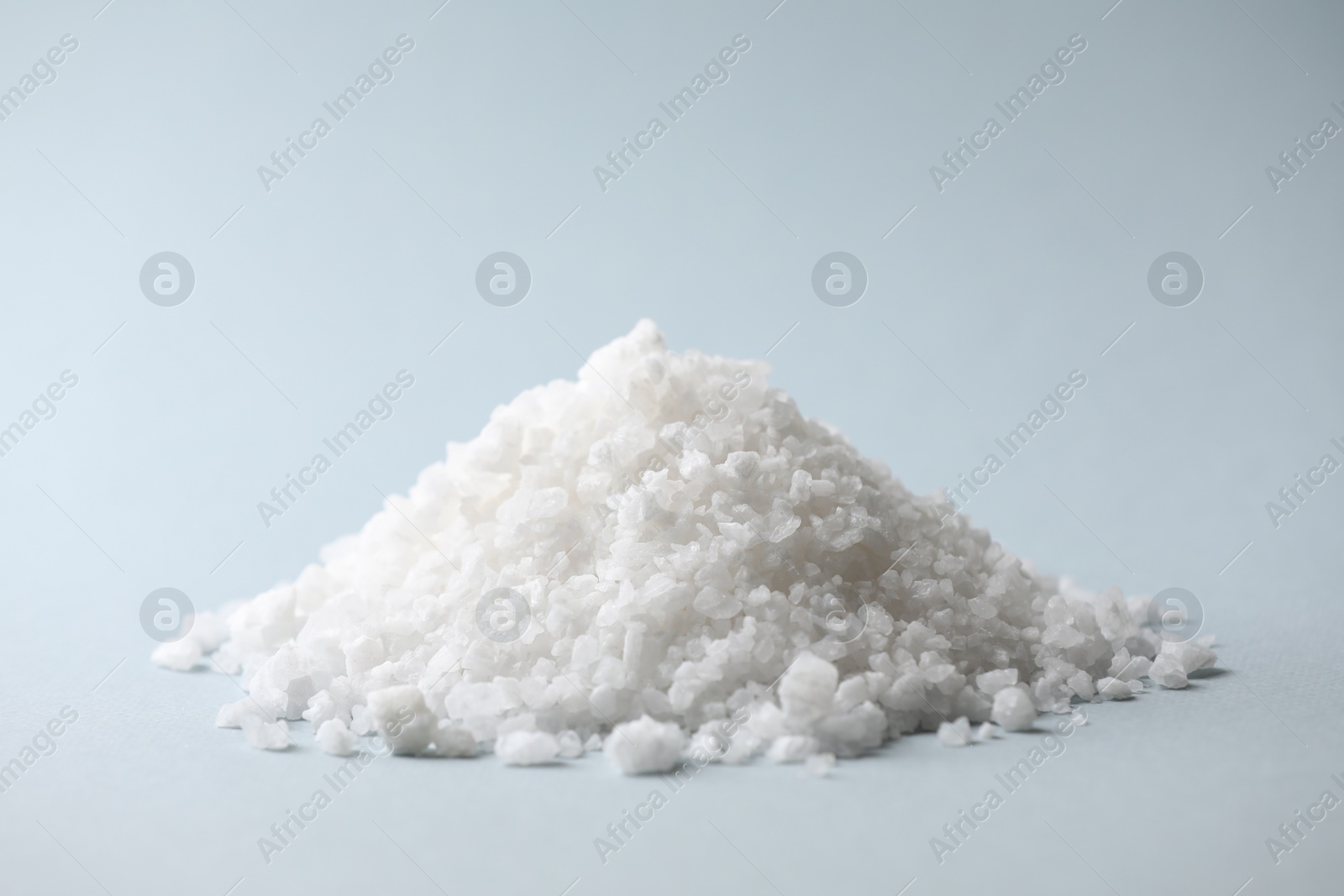 Photo of Heap of natural salt on color background