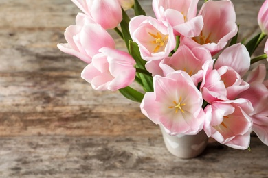 Photo of Beautiful tulips for Mother's Day on table, top view