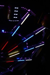 Illuminated attraction in amusement park at night