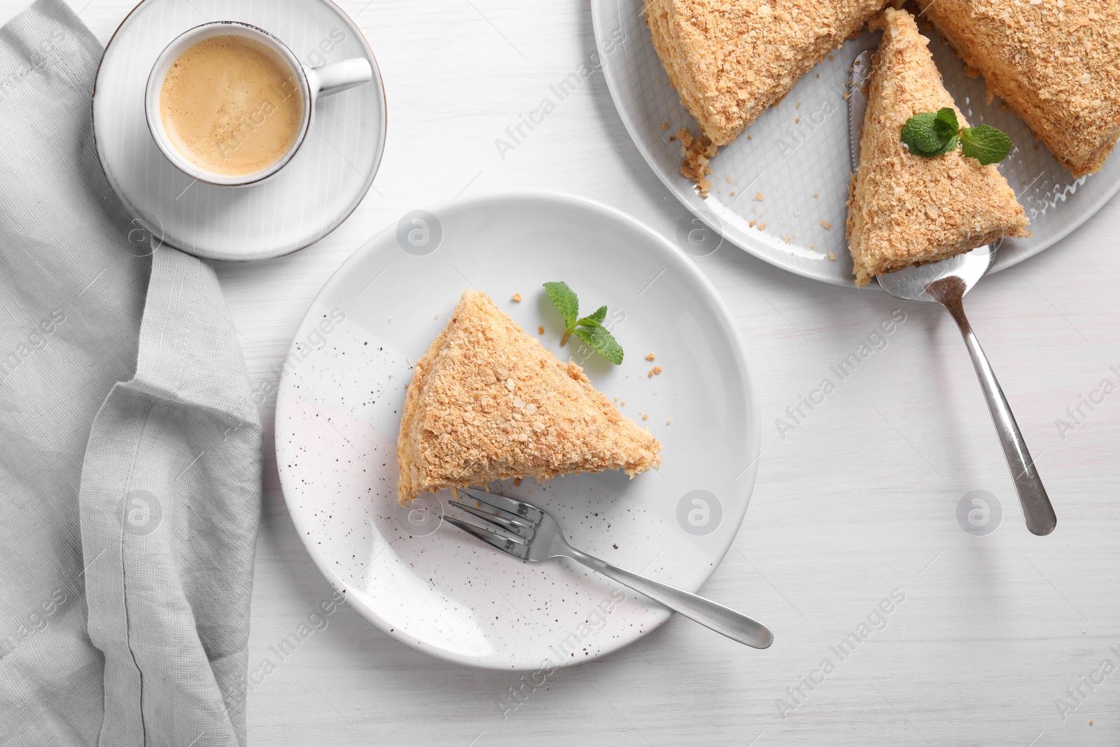 Photo of Delicious Napoleon cake served on white wooden table, flat lay
