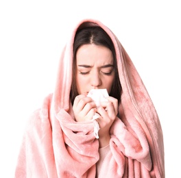 Young woman with cold sneezing on white background
