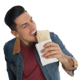 Man eating delicious shawarma on white background