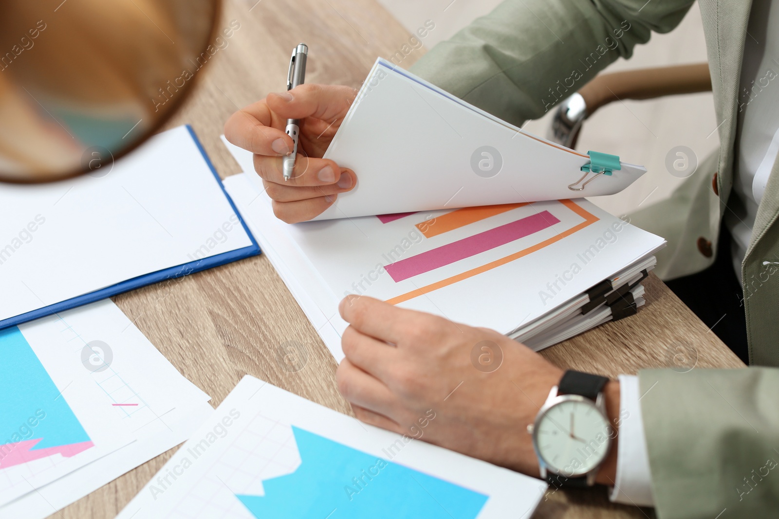 Photo of Businessman working with documents at office table, closeup