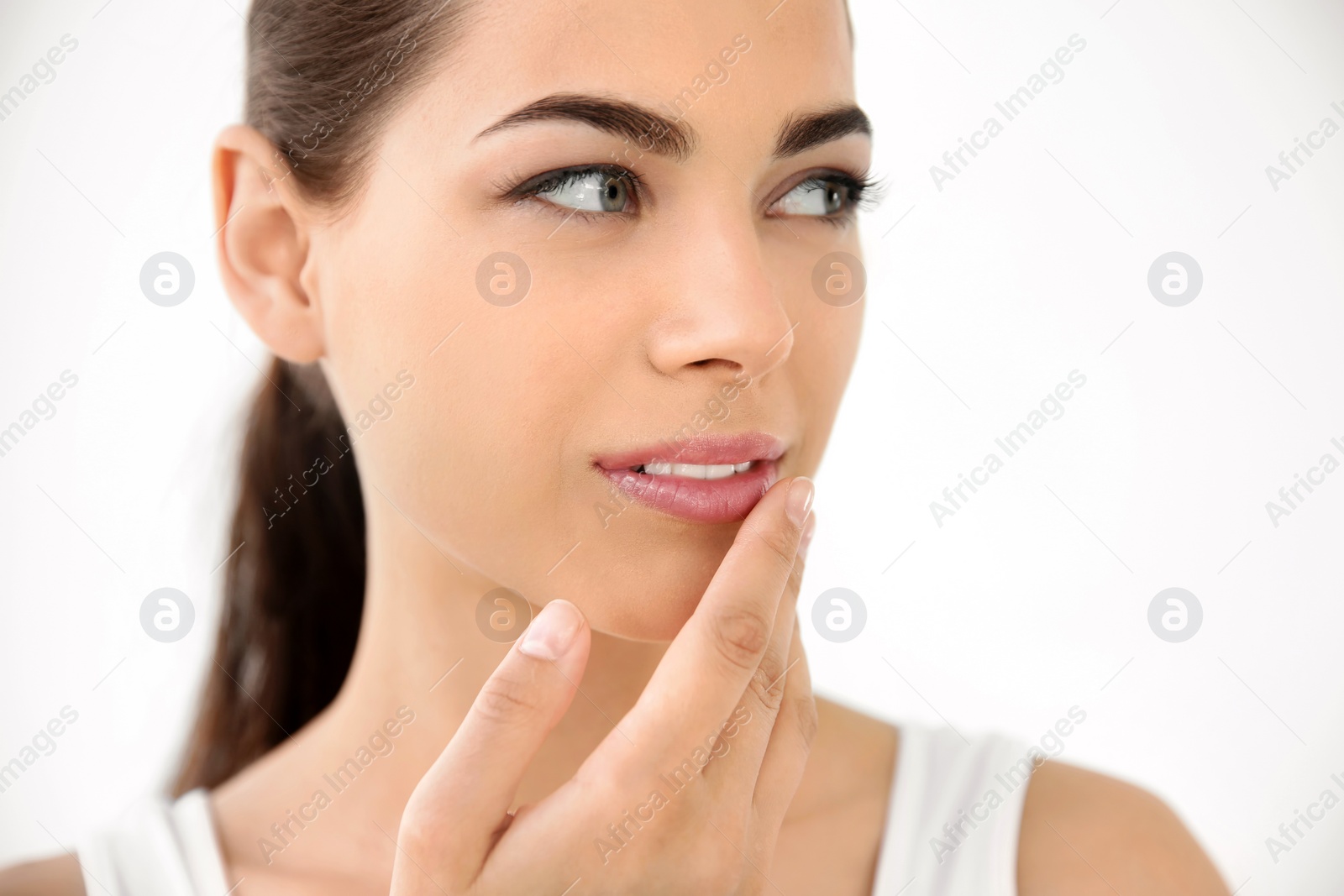 Photo of Young woman with sexy lips on light background