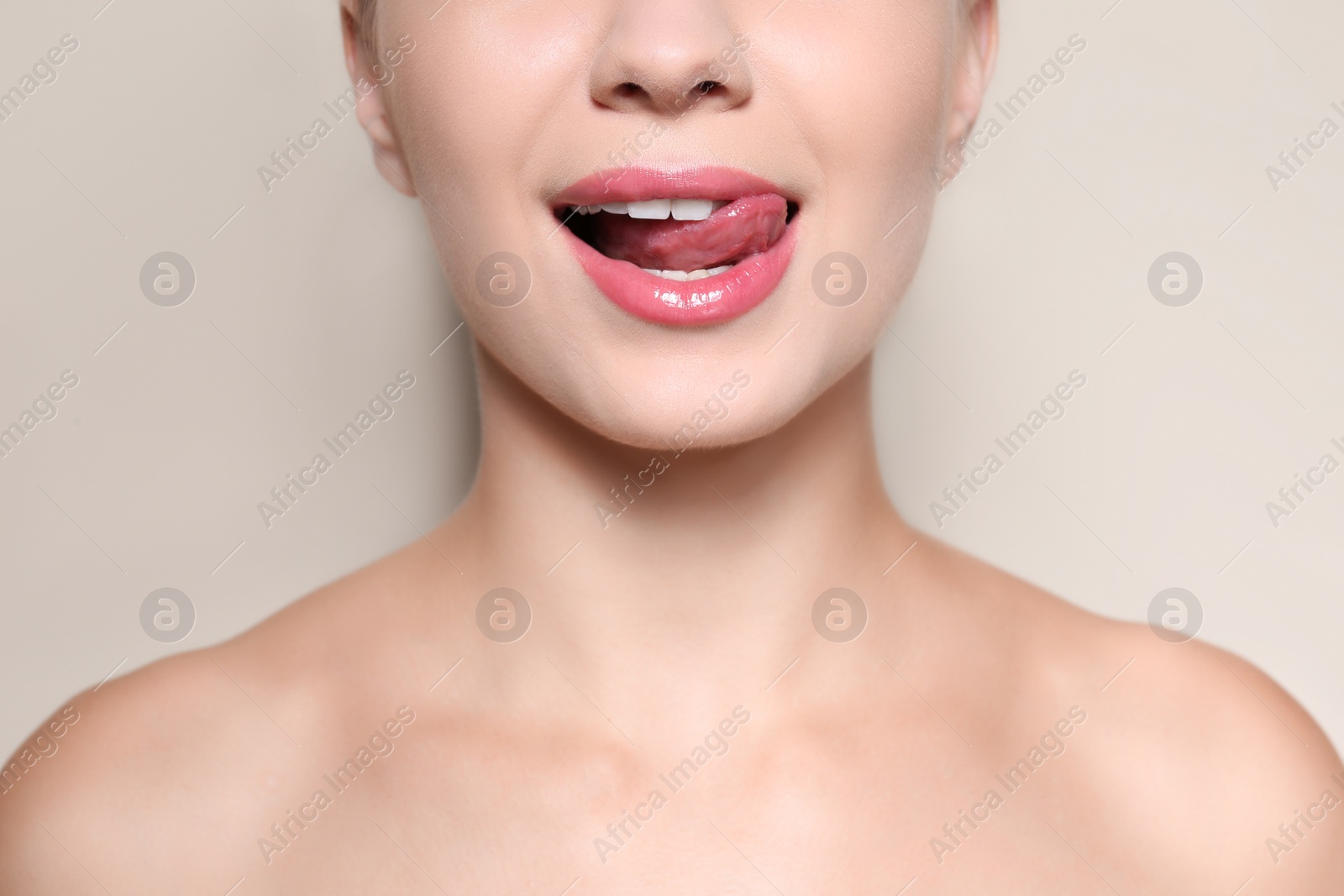 Photo of Beautiful young woman with perfect lips makeup on light background, closeup