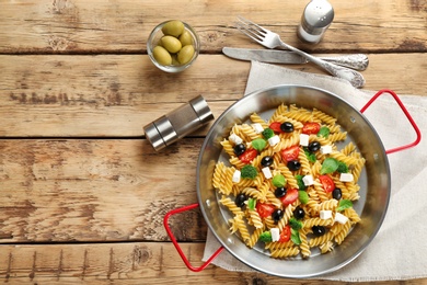 Dish with delicious pasta primavera on table, top view