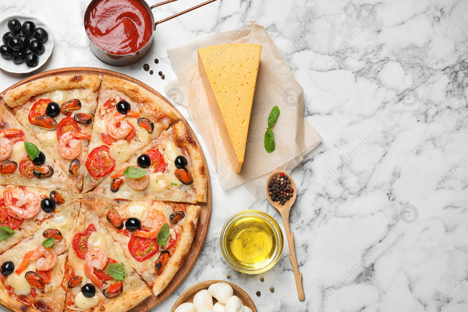 Photo of Tasty pizza with seafood and ingredients on white marble table, flat lay. Space for text