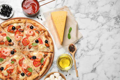 Photo of Tasty pizza with seafood and ingredients on white marble table, flat lay. Space for text