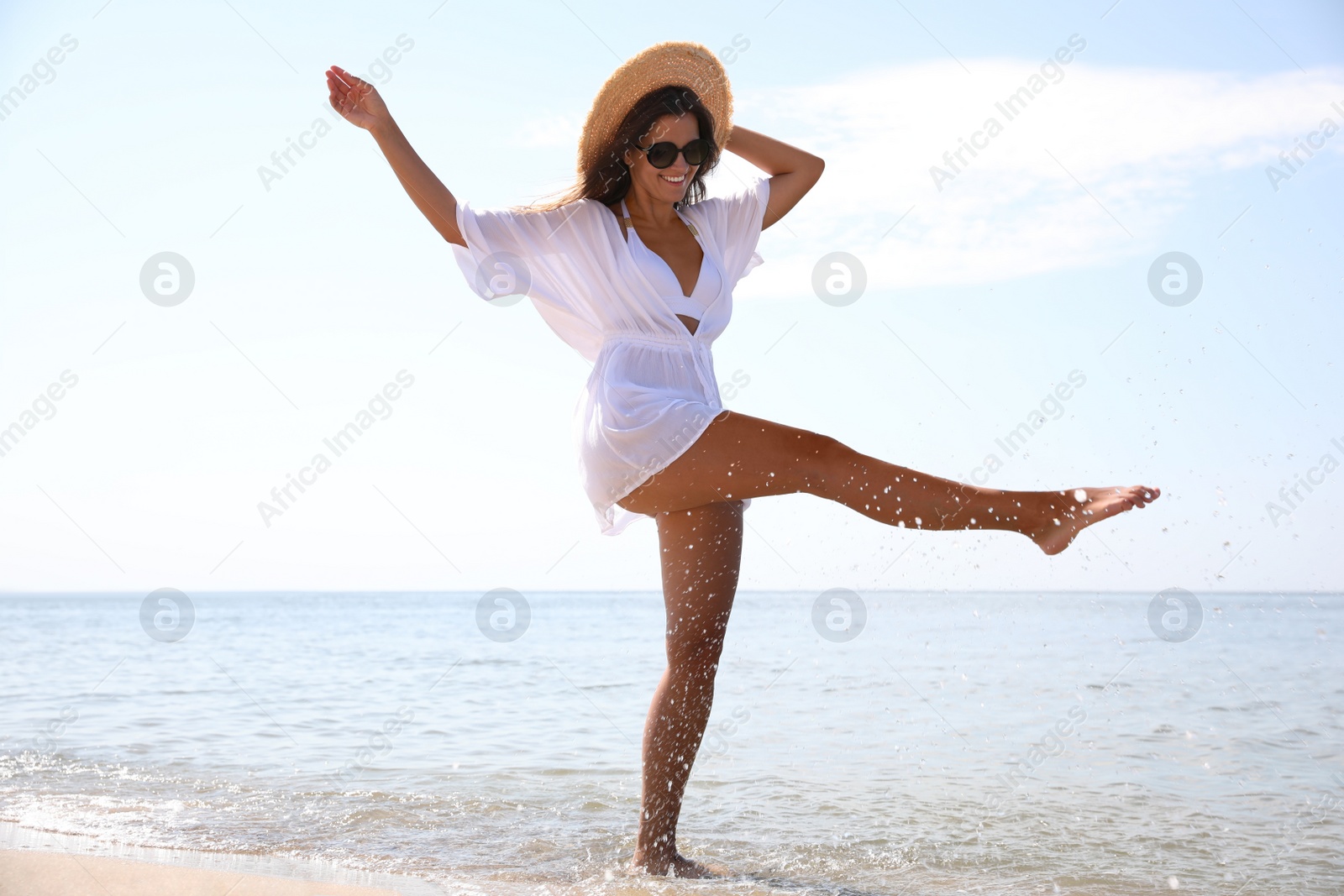 Photo of Young woman with beautiful body on beach