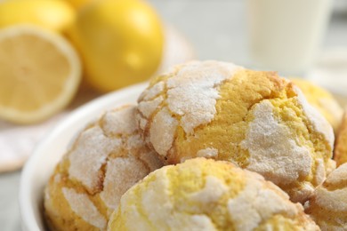 Photo of Many delicious lemon cookies in bowl, closeup