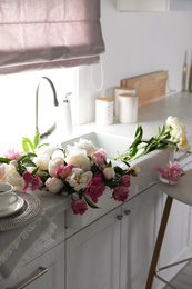 Bunch of beautiful peonies in kitchen sink