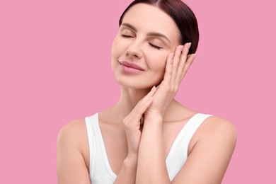 Beautiful woman with healthy skin on pink background. Body Care