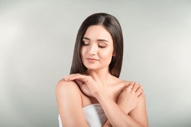 Photo of Portrait of beautiful woman on grey background. Cosmetology and spa