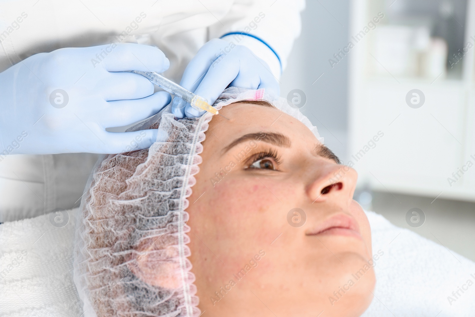 Photo of Woman undergoing face biorevitalization procedure in salon, closeup. Cosmetic treatment