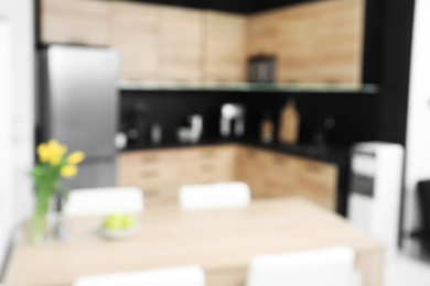 Blurred view of cozy modern kitchen interior with new furniture and appliances