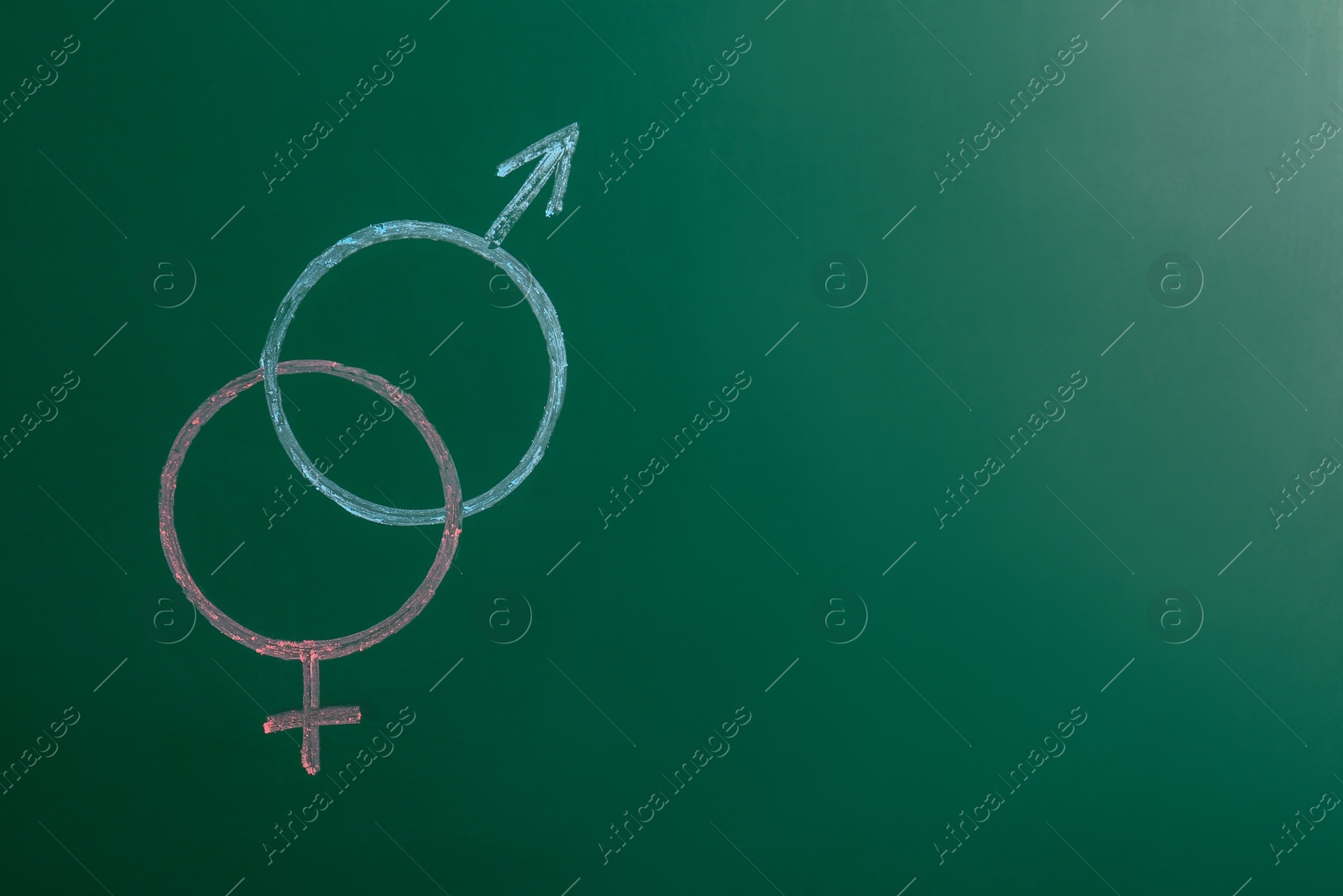 Photo of Gender symbols drawn on green chalkboard, space for text. Sex education