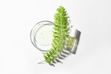 Petri dish with sample, leaf and bottle on white background, top view