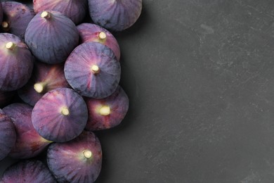 Fresh ripe figs on black table, flat lay. Space for text