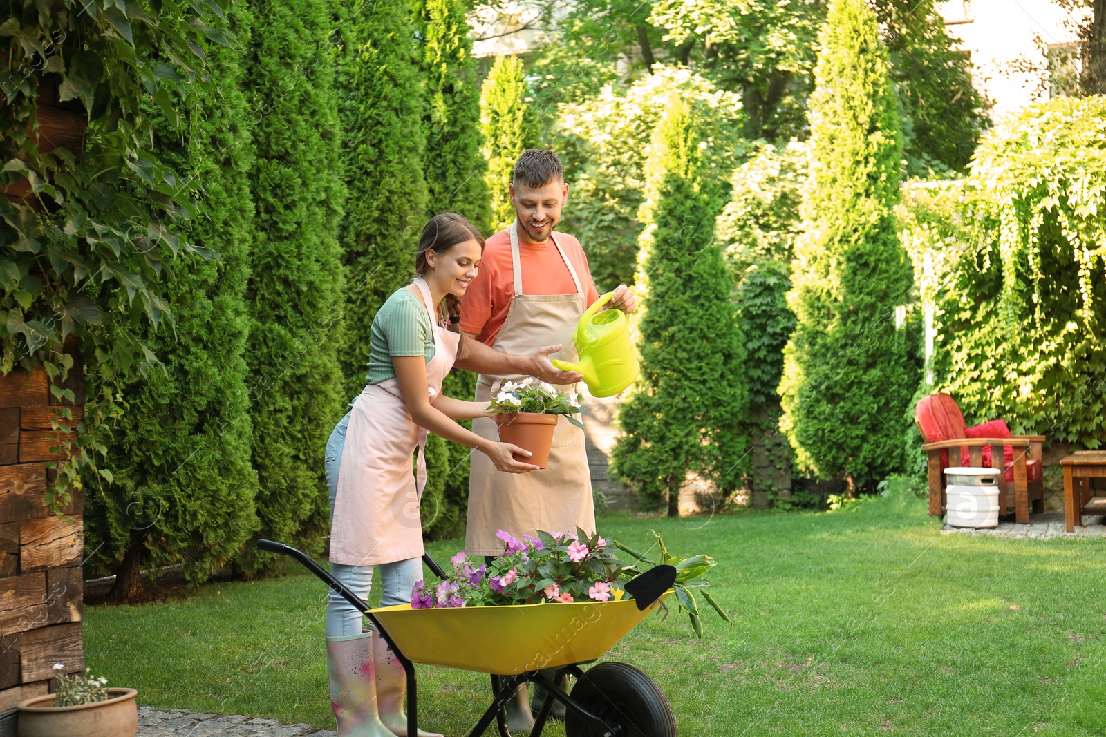 Photo of Happy couple working together in green garden