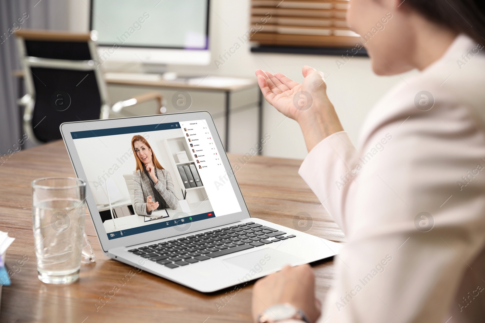 Image of Woman having video chat with team at table, closeup