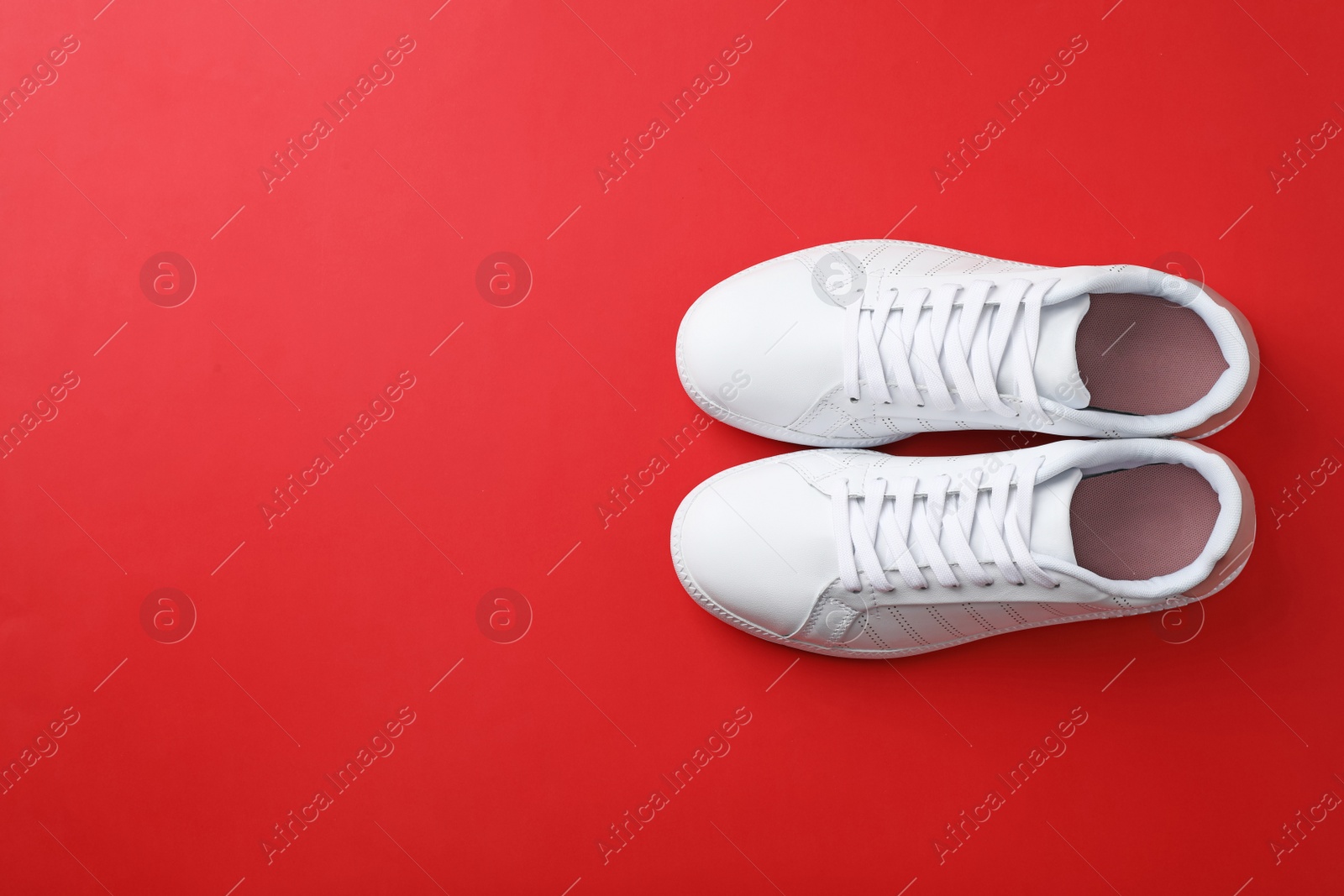 Photo of Pair of sneakers on color background, flat lay. Space for text