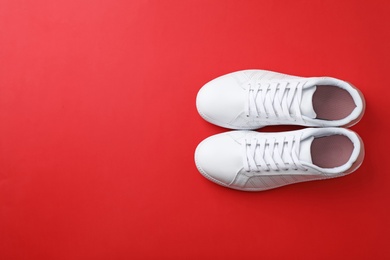 Photo of Pair of sneakers on color background, flat lay. Space for text