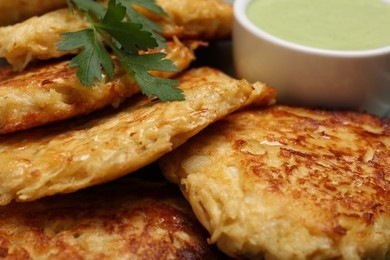 Photo of Tasty parsnip cutlets with sauce, closeup view