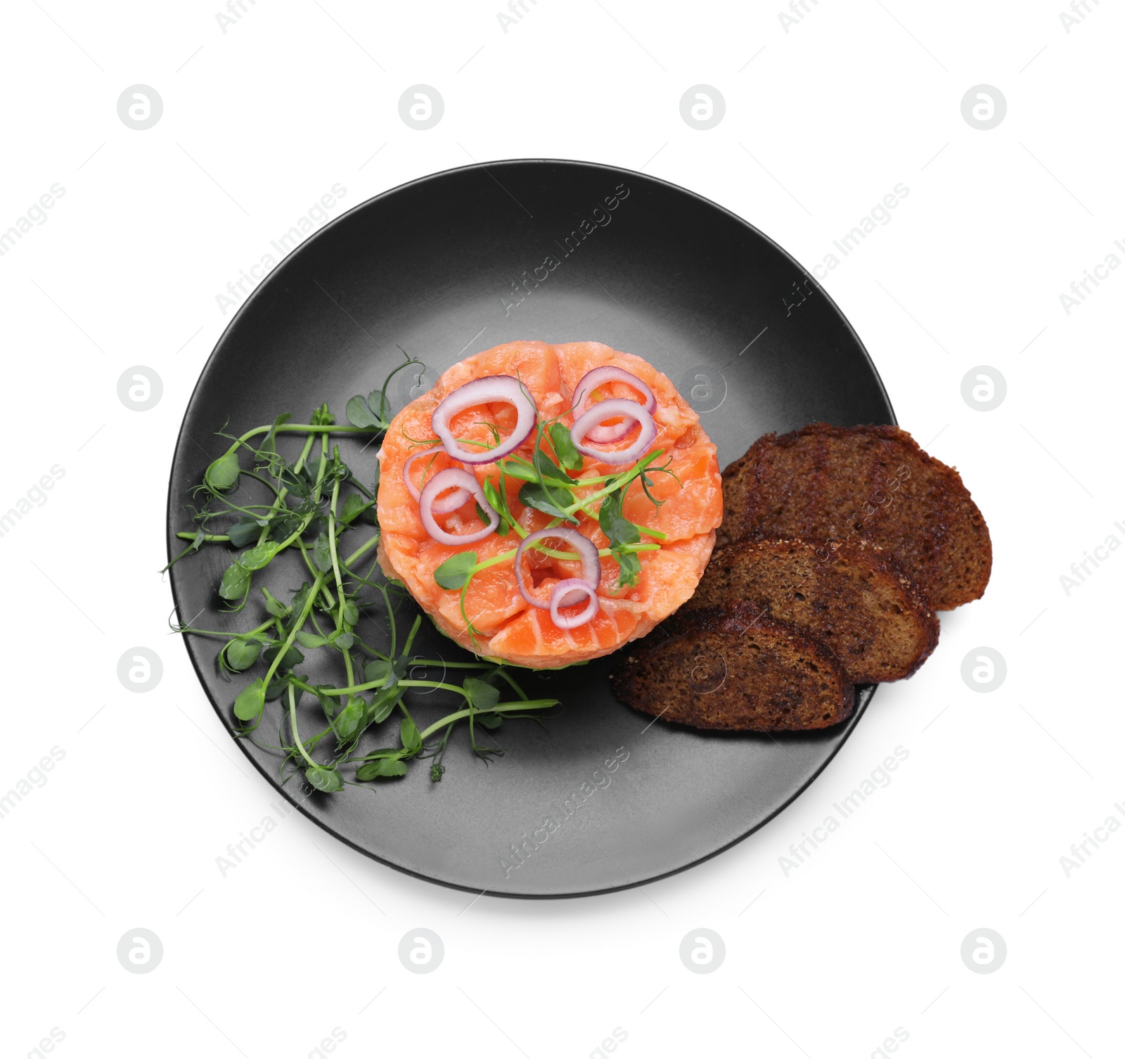 Photo of Tasty salmon tartare with croutons, microgreens and red onion isolated on white, top view